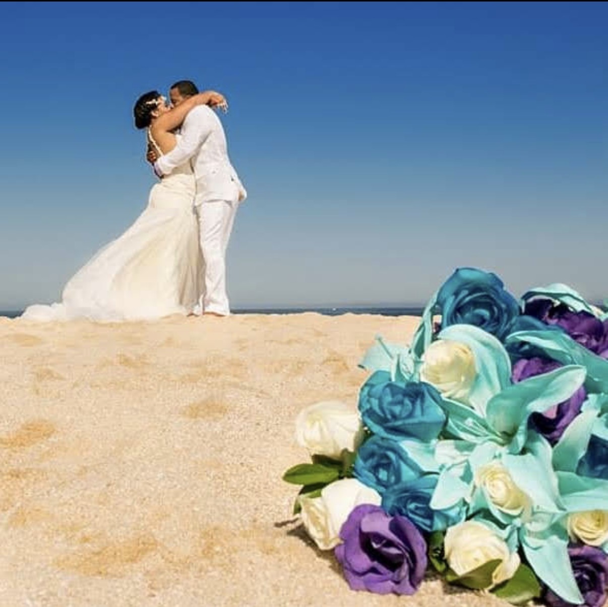 Vybe destination wedding couple celebrating on the beach